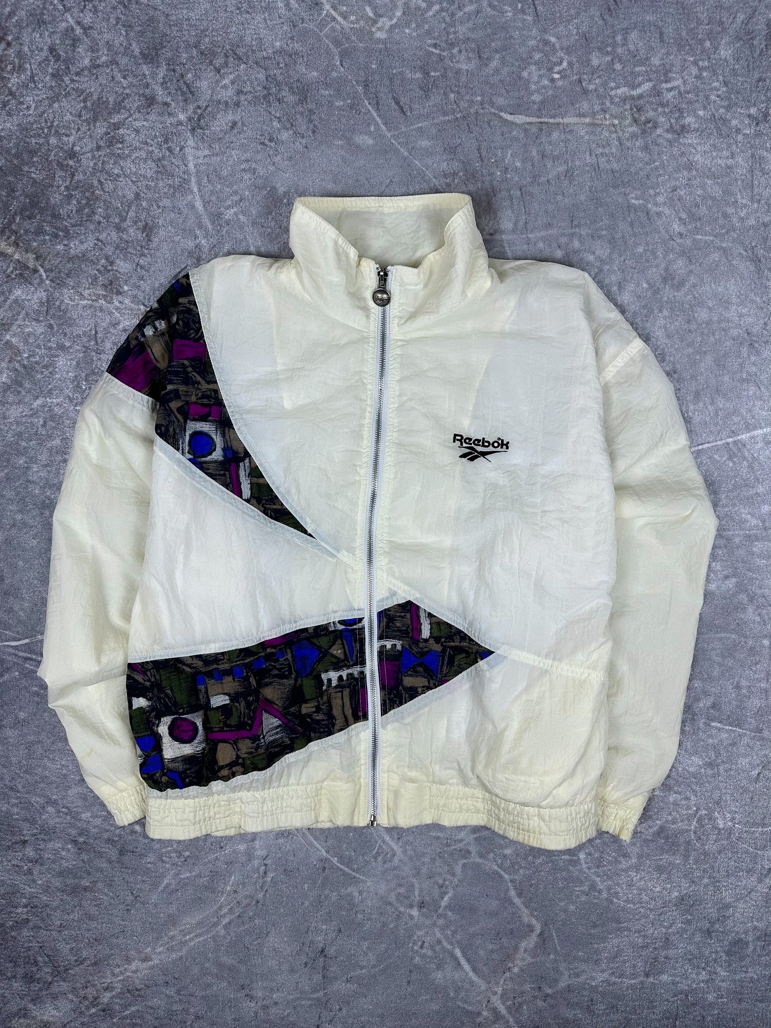 Vintage 90s Reebok Embroidered Logo Abstract Wrap Around Print Windbreaker Jacket (M)